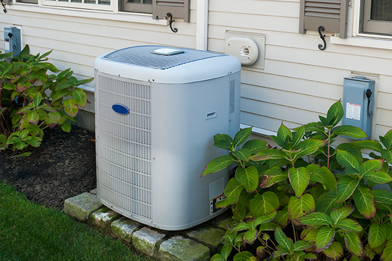 Prepare for Hot Weather With an Air Conditioning Tune-up. Photo of an HVAC Unit installed outside of a home or building.